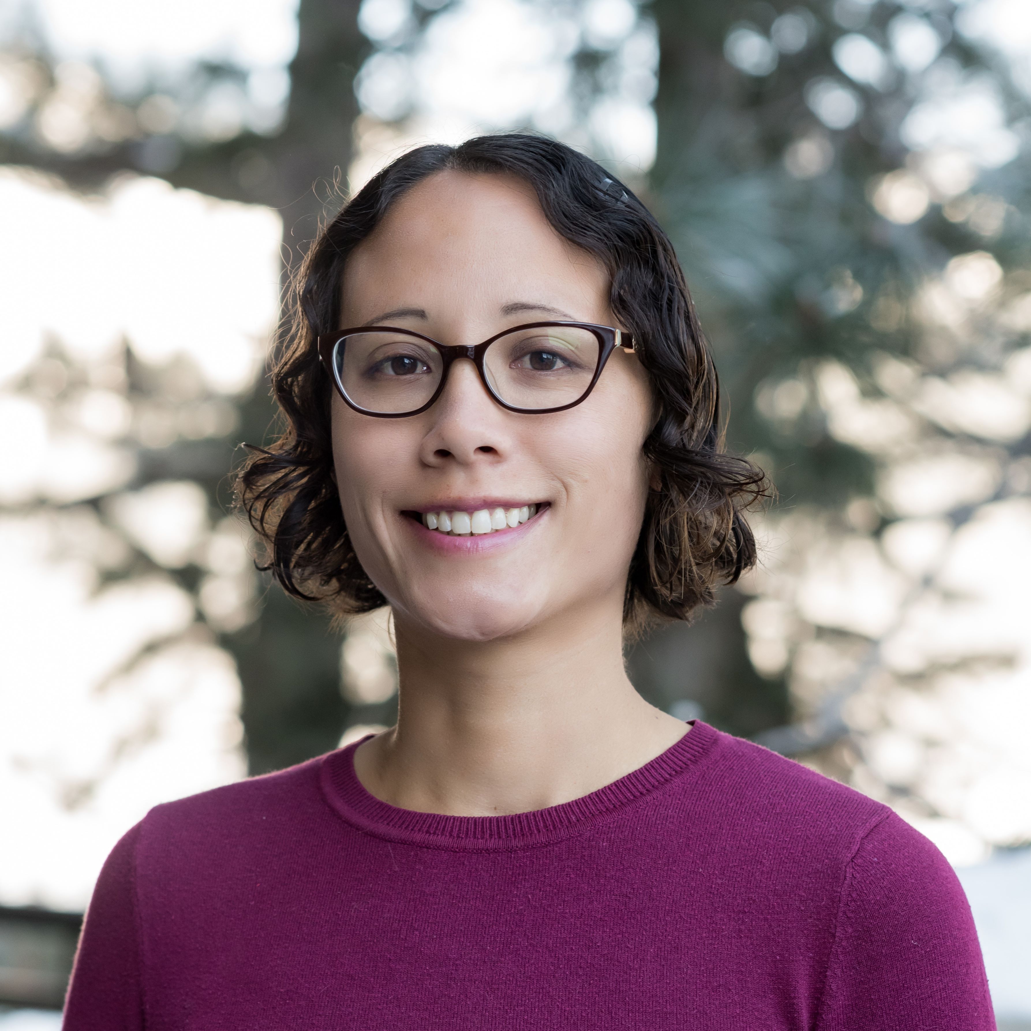 Portrait of Monica Moritsch smiling outdoors among trees